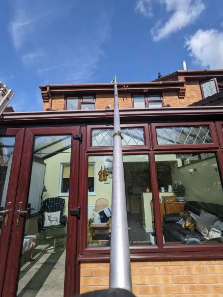 gutter vacuum cleaning over a conservatory